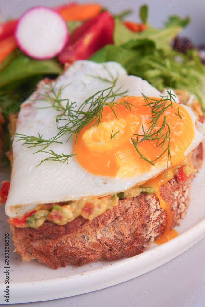 Savor delicious Avocado Toast with a Fried Egg, served with a Fresh Salad on the side Savor delicious Avocado Toast with a Fried Egg, served with a Fresh Salad on the side