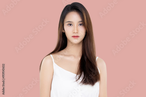 Beautiful young Asian woman with K beauty style makeup and perfect skin on isolated pink background. Facial and skin care concept for commercial advertising.