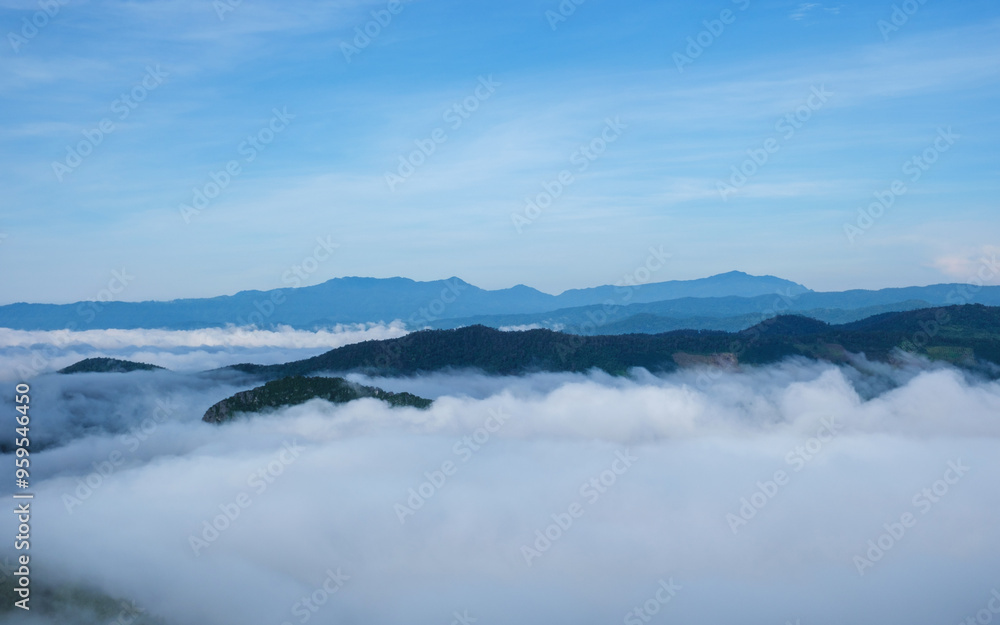 Landscape image of mountains peak with sea of clouds and blue sky Landscape image of mountains peak with sea of clouds and blue sky