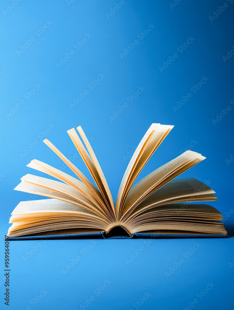 Naklejka premium Open book on blue background