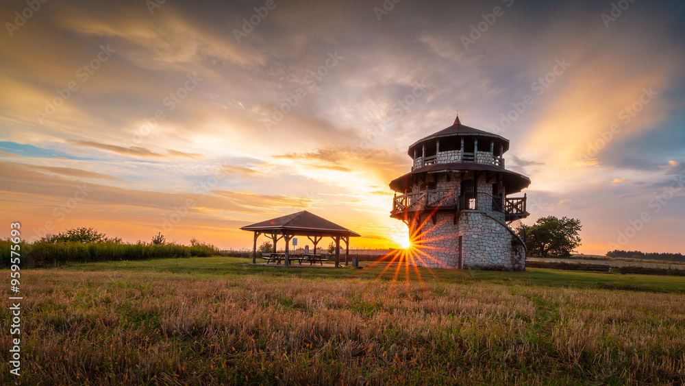 A beautiful view tower made of stone against the background of a wonderful landscape at sunset. Multicolored hot sky. Susiec, Roztocze, Poland