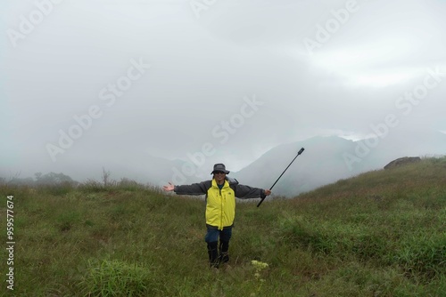 hikers backpacks standing on top of a mountain and enjoying nature view 