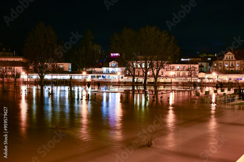 Bad Kissingen bei Nacht und Hochwasser - Spiegelung der Beleuchtung des Regentenbau und der Ludwigsbrücke im Fluss Saale mit Hochwasser bei Nacht im Winter, Franken, Bayern, Deutschland photo