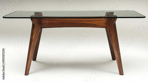 Modern glasstopped dining table with wooden legs centered on a white background photo