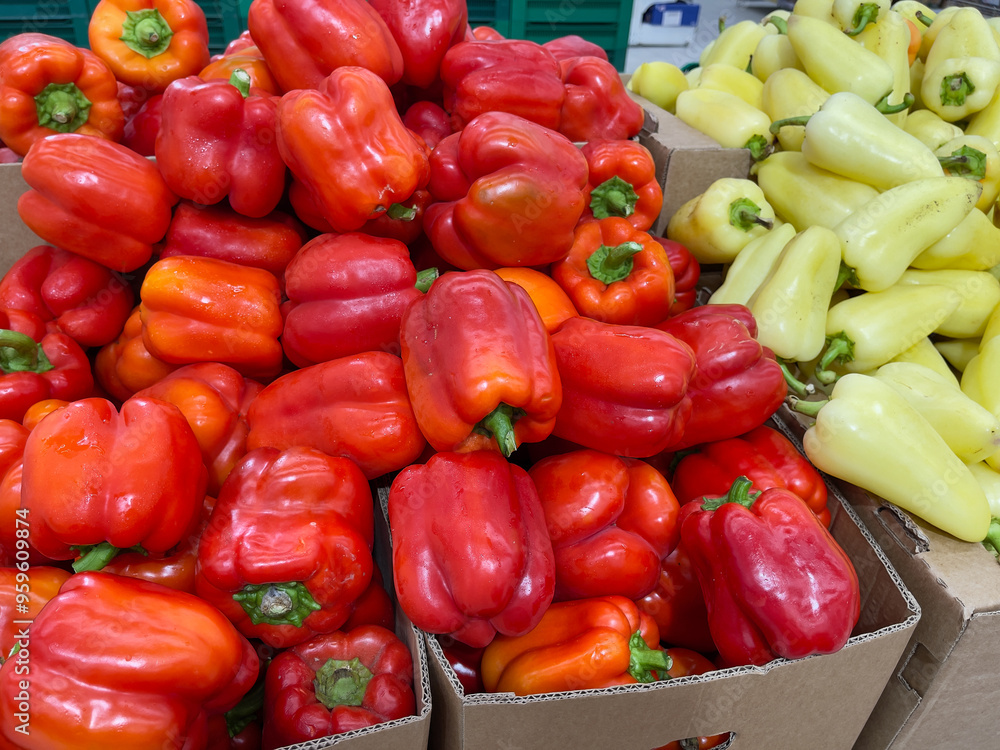 Red and yellow bell peppers on a market stall. Close up. Red and yellow bell peppers on a market stall. Close up.