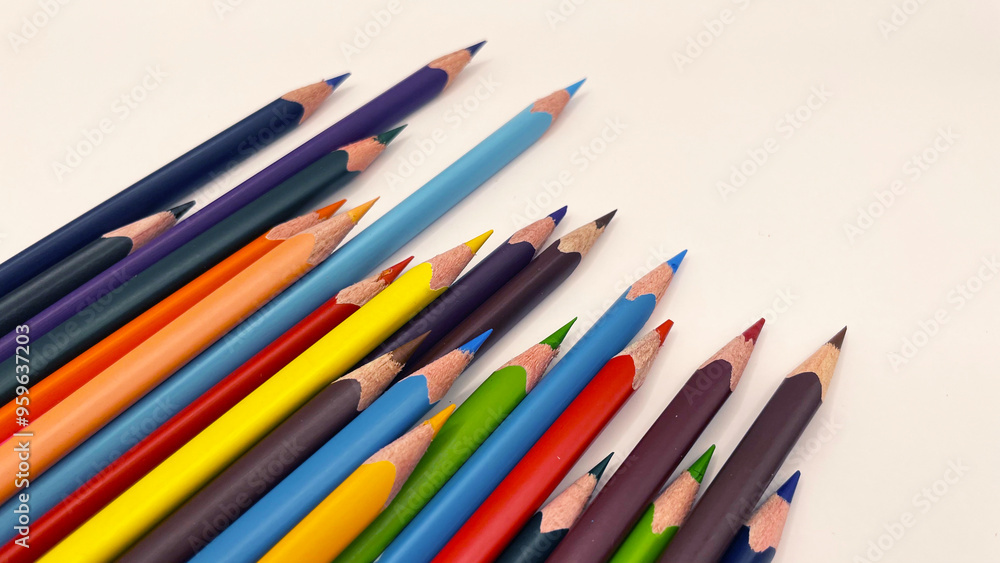 Colorful sharpened pencils are lined up on the table. Colorful sharpened pencils are lined up on the table.