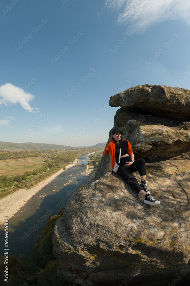 Woman on Rock Overlooking Scenic River Woman on Rock Overlooking Scenic River
