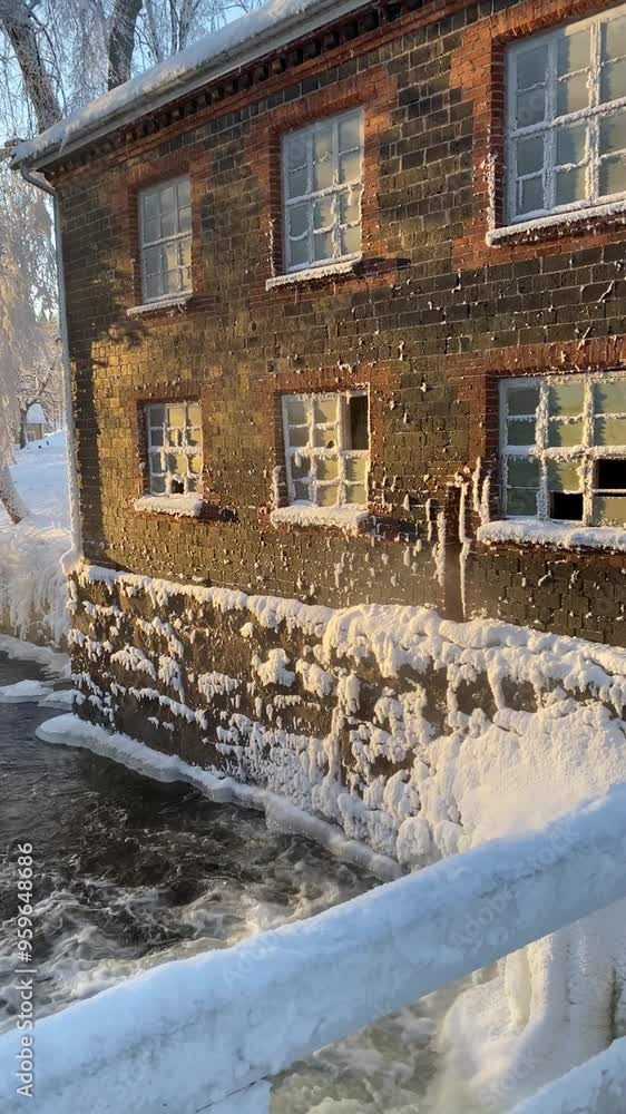 old brick house on the riverbank in winter in the village of Fiskars old brick house on the riverbank in winter in the village of Fiskars