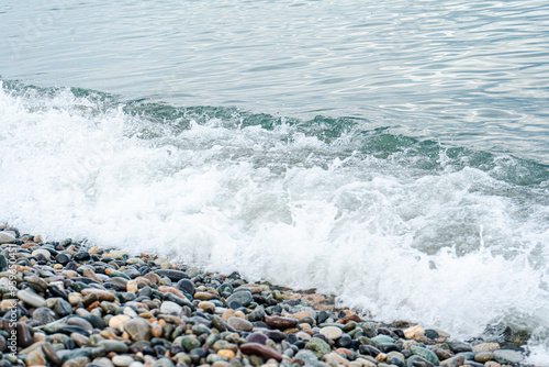 Sea waves on the pebbles shore photo