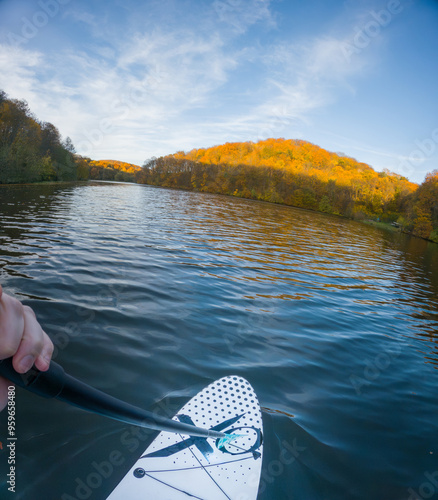 Paddleboarding on a Serene Autumn Lake photo