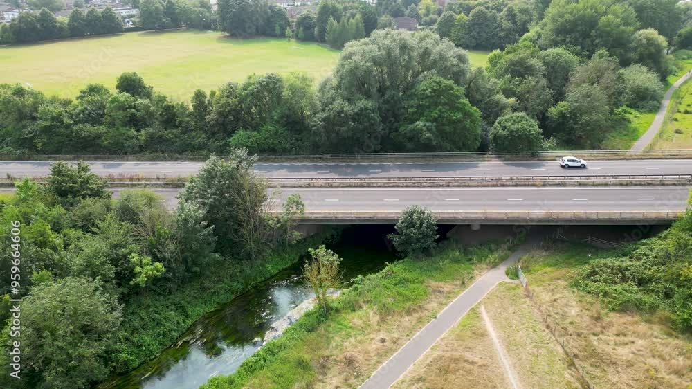 Smooth reverse panning aerial movement about the A2 roadway of Hambrook Marshes, Canterbury, United Kingdom.