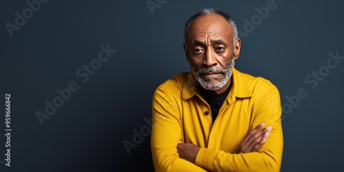 Yellow background sad black American independent powerful man. Portrait of older mid-aged person beautiful bad mood expression isolated on background