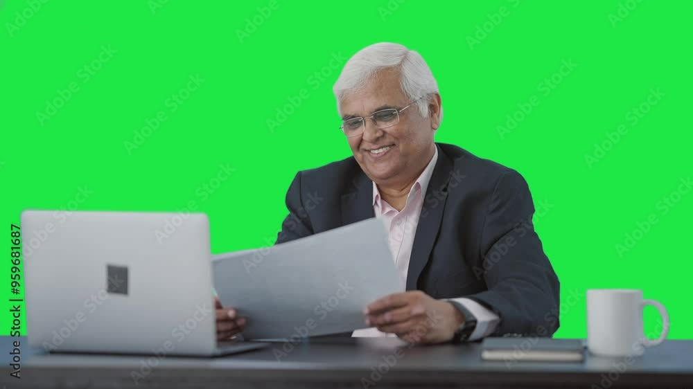 Happy Indian senior manager reading business reports Green screen Happy Indian senior manager reading business reports Green screen