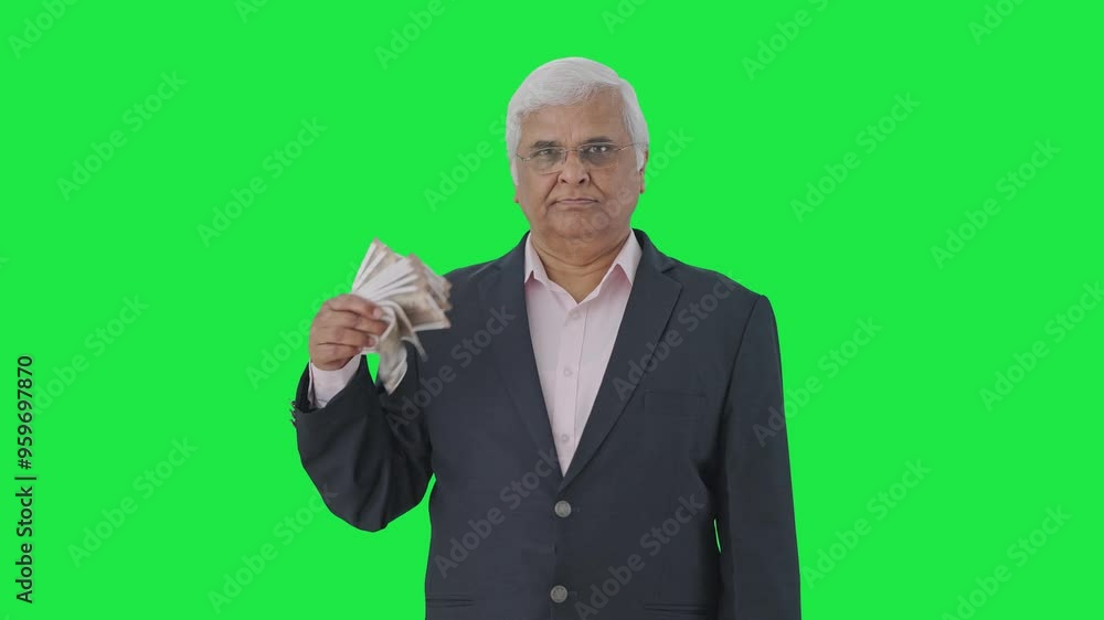 Confident Indian senior manager using money as fan Green screen Confident Indian senior manager using money as fan Green screen