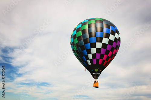 Hot air balloon against a blue sky with white clouds. photo