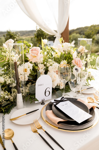 Styled wedding reception table with florals and place setting