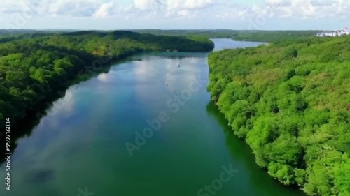 Stunning aerial view capturing serene waters surrounded by lush greenery, an ideal scene for travel and nature enthusiasts