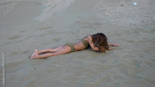 8 year old girl playing on the beach. Child girl enjoying sand on beach photo