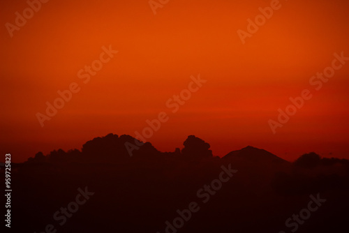 orange sky at dusk with cloud silhouettes