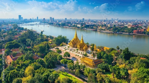 Top view of Phnom Penh's Royal Palace complex, with golden spires glistening under the bright blue sky and riverbank views.