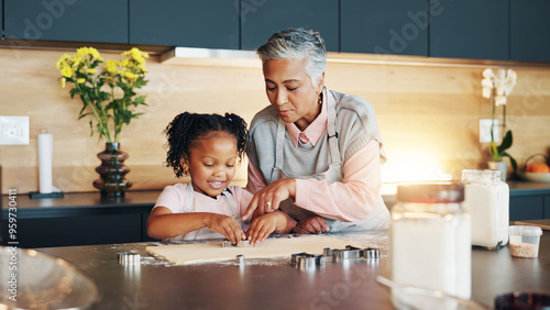 Cuadro en lienzo Grandma, little girl and baking with cookie cutter on table in kitchen for learning, teaching or making dough at home
