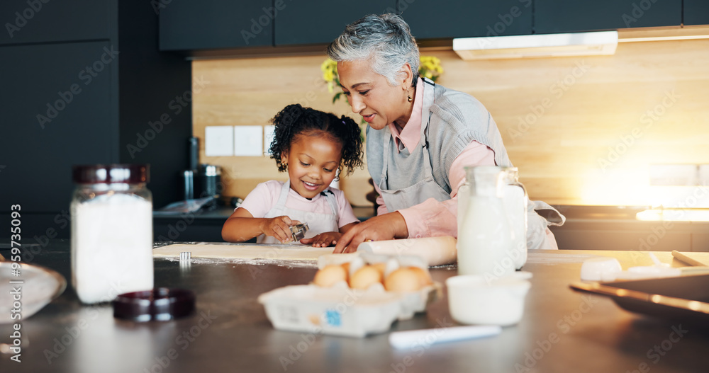Grandmother, little girl and baking with cookie cutter on table in kitchen for learning, teaching or making dough at home. Grandma, child or junior baker with shapes for dessert or recipe at house Grandmother, little girl and baking with cookie cutter on table in kitchen for learning, teaching or making dough at home. Grandma, child or junior baker with shapes for dessert or recipe at house