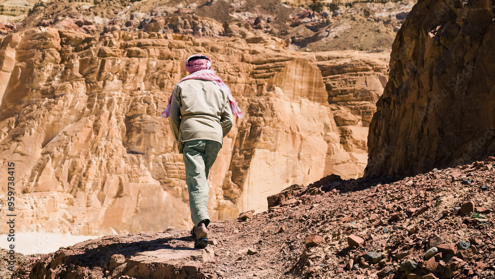 Bedouin climbs a mountain in a canyon in Egypt Dahab South Sinai Bedouin climbs a mountain in a canyon in Egypt Dahab South Sinai