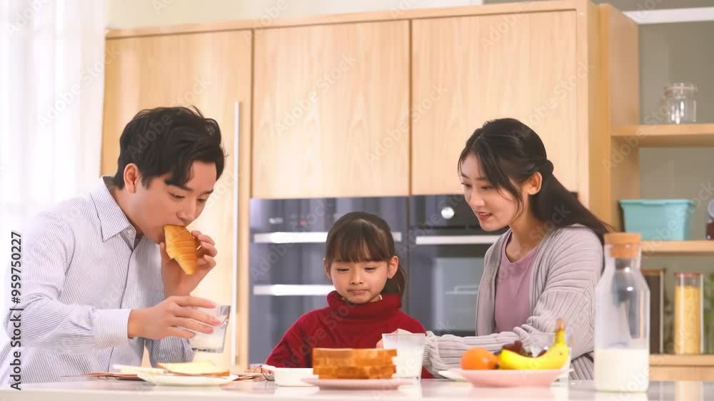 Young happy family having healthy breakfast together in the morning in the kitchen at home Young happy family having healthy breakfast together in the morning in the kitchen at home