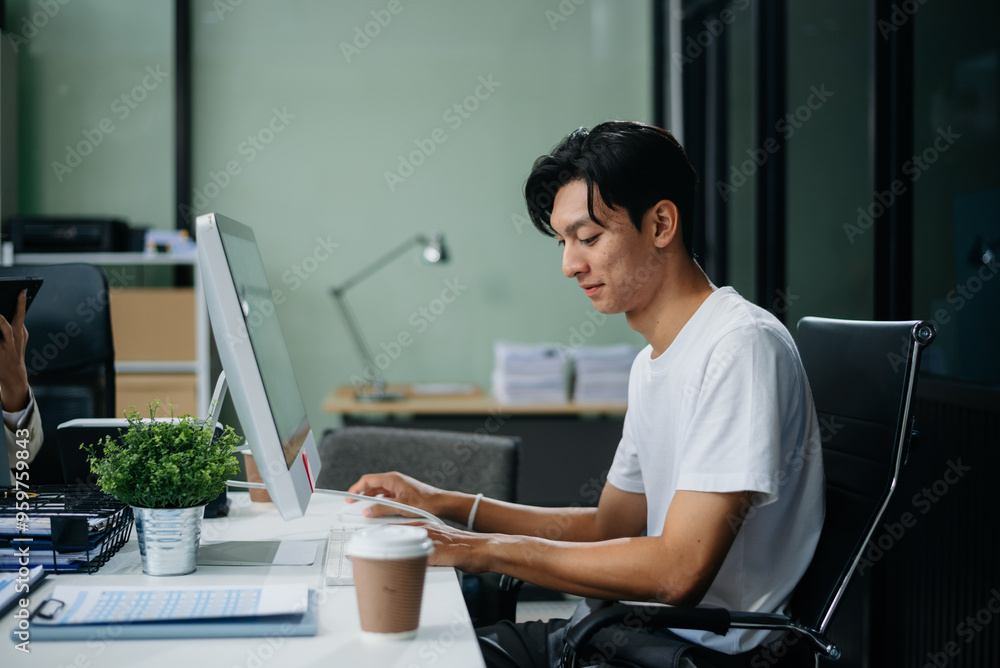 Young business man working at office with laptop, tablet and taking notes on the paper. Young business man working at office with laptop, tablet and taking notes on the paper.