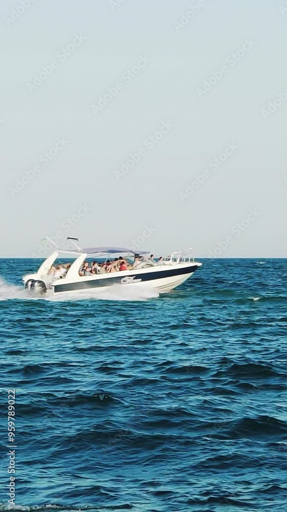Small cruise ship with passengers. Small ferry with passengers crossing sea. Vertical video Small cruise ship with passengers. Small ferry with passengers crossing sea. Vertical video