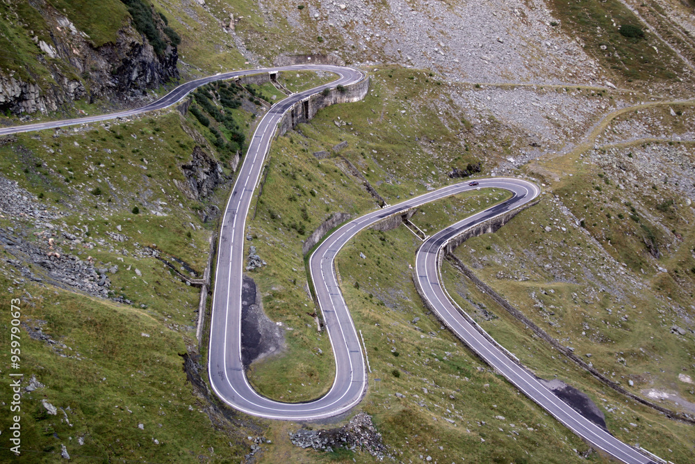 Landscape photo with view of green rocky mountains and Transfagarasan mountain road in Romania	