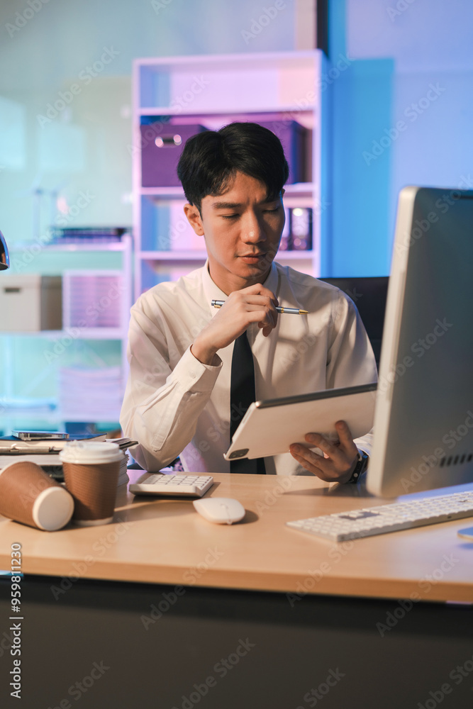 Fototapeta premium stressed asian male businessman working in the office.Man thinking too much work concept in the office, employees working overtime.