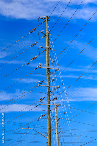 Canvas Print A wooden electric pole with multiple cables against a clear blue sky