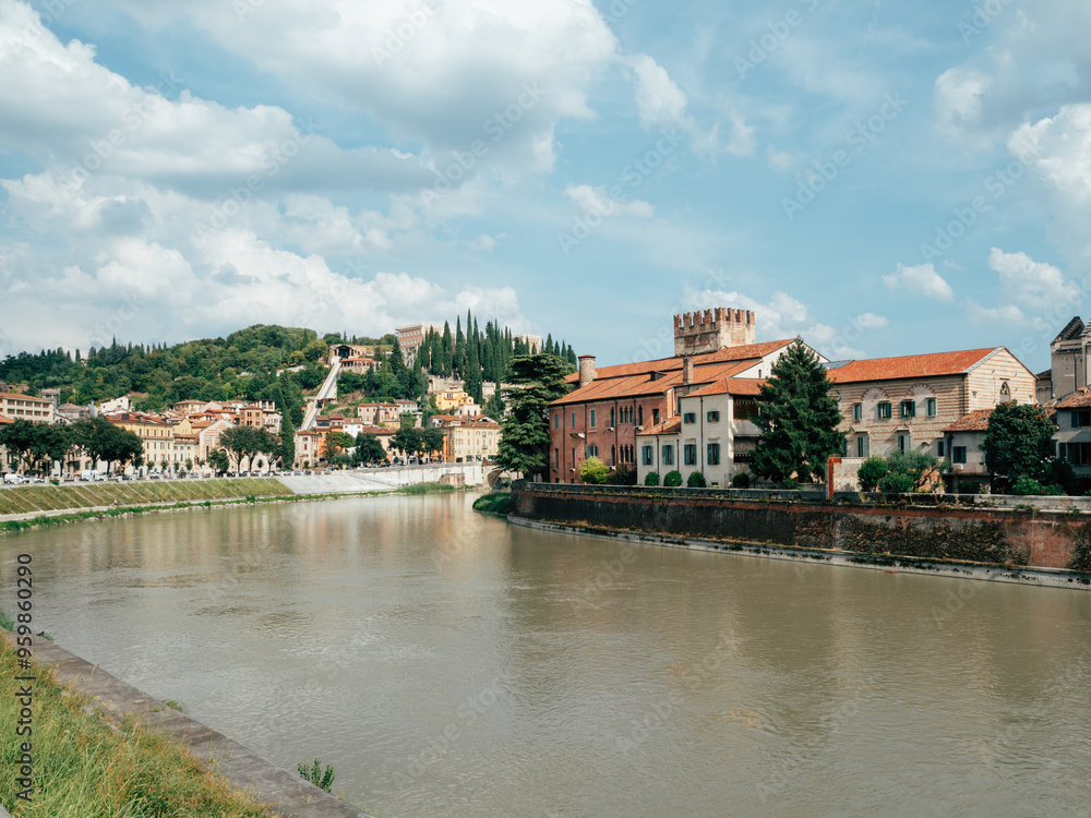 A serene view of historic buildings along the river in Florence, Italy on a sunny afternoon with clouds in the sky A serene view of historic buildings along the river in Florence, Italy on a sunny afternoon with clouds in the sky