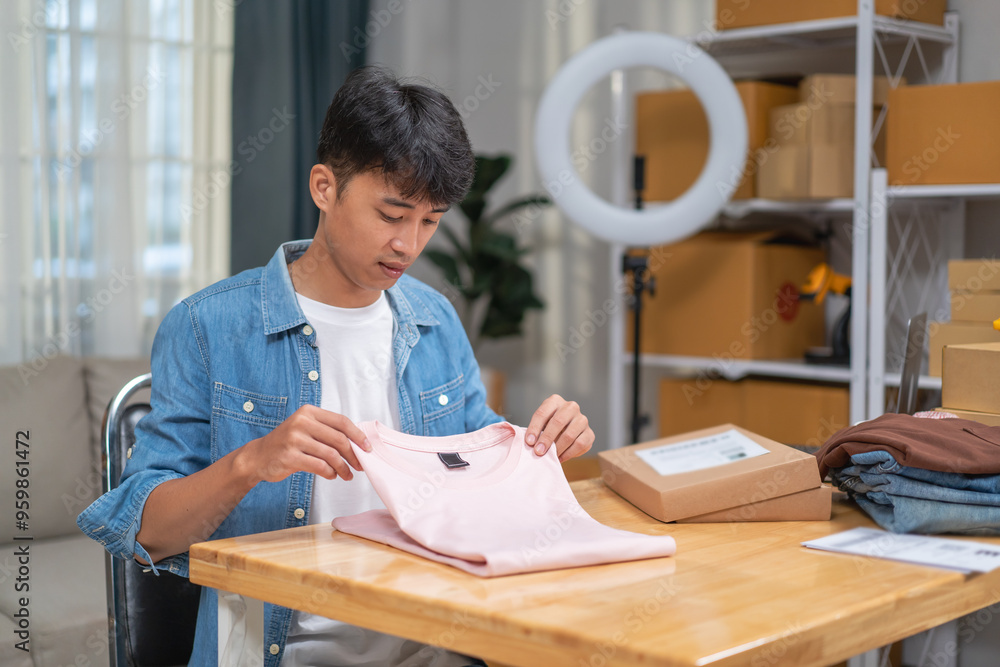 Young Asian man, distributor, online shop owner, small business owner, standing in warehouse and preparing to ship goods, with parcel boxes. Young Asian man, distributor, online shop owner, small business owner, standing in warehouse and preparing to ship goods, with parcel boxes.