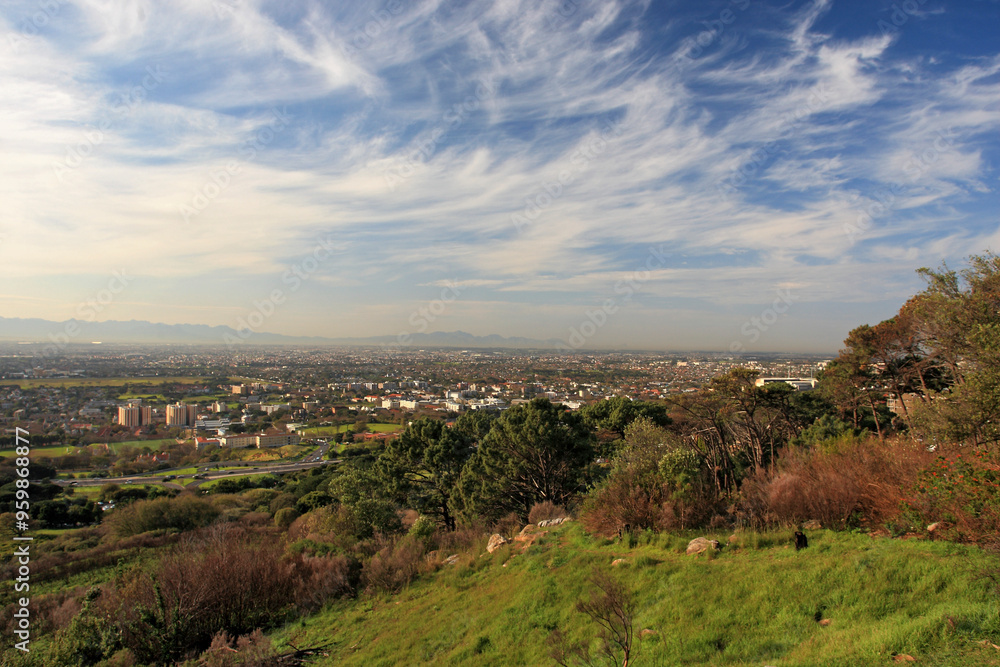 View of beautiful cityscape with greenery and skyline under a cloudy sky, Cape Town, South Africa.
