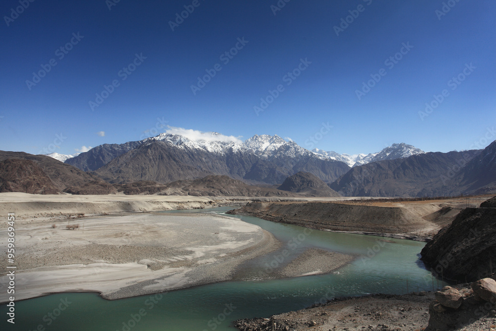 View of the majestic Indus River winding through rugged mountains under a clear sky, Skardu, Pakistan. View of the majestic Indus River winding through rugged mountains under a clear sky, Skardu, Pakistan.