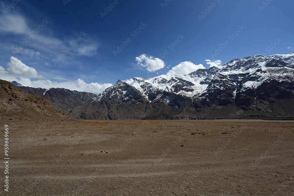 View of majestic snow-capped mountains under a dramatic sky with clouds, Skardu, Pakistan. View of majestic snow-capped mountains under a dramatic sky with clouds, Skardu, Pakistan.
