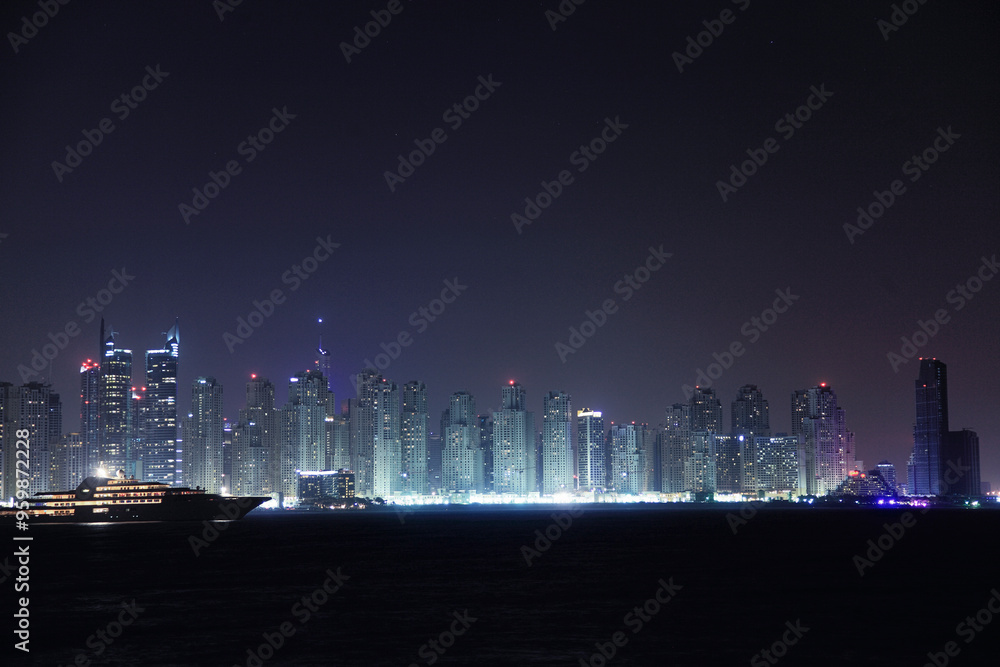 View of illuminated skyline with modern skyscrapers in a colorful desert city, Dubai, United Arab Emirates. View of illuminated skyline with modern skyscrapers in a colorful desert city, Dubai, United Arab Emirates.