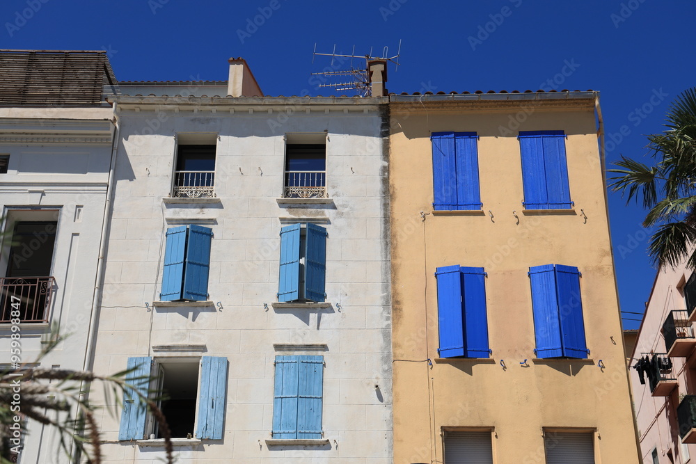 Obraz premium Colourful housefronts featuring traditional wooden window shutters in Mediterranean port town of Port-Vendres in Pyrénées-Orientales department, France