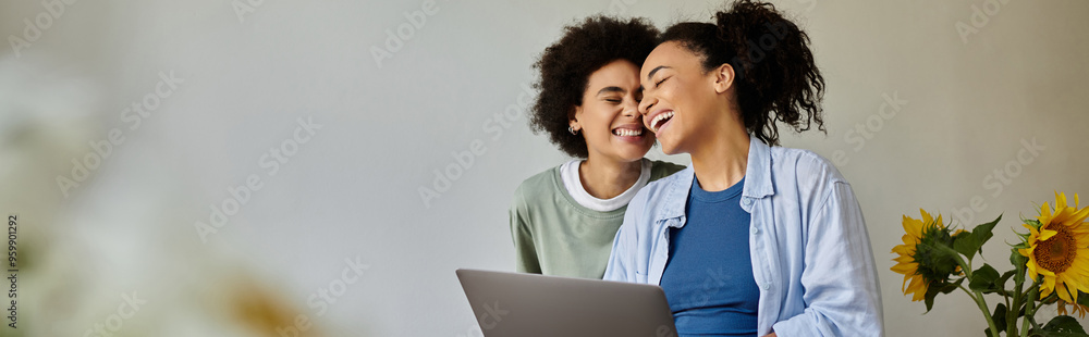 Two women share laughter and affection while enjoying a cozy day together. Two women share laughter and affection while enjoying a cozy day together.