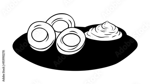 Plate of hard-boiled eggs, sliced in half, beside a small bowl of mayonnaise