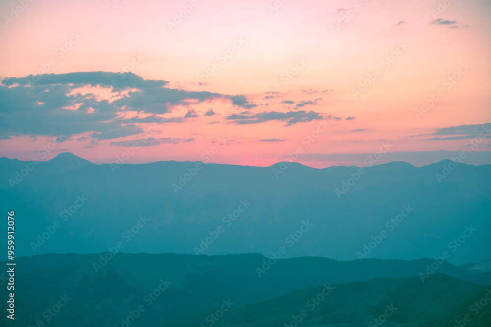 Obraz premium Silhouettes of mountains in a beautiful gentle haze, mountains at sunset or sunrise, natural background