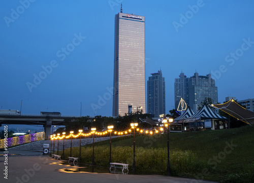 Yeouido, Yeongdeungpo-gu, Seoul, South Korea - May 21, 2021: Night view of Han River Citizens Park with street lamp against Mapo Bridge and 63 Building in the background photo