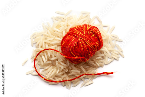 A pile of rice with kalawa (pooja thread). Isolated on a white background. photo