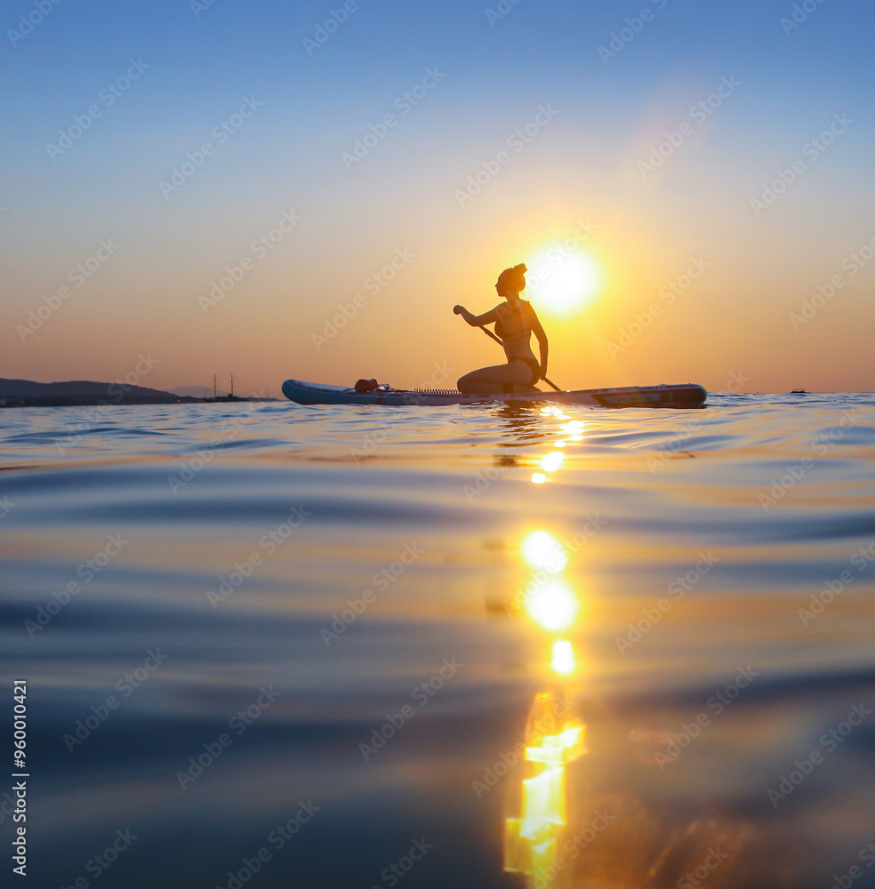 sup surfing in the sea