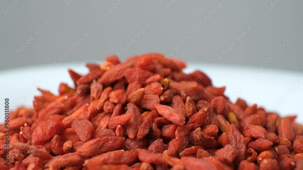 Macro rotation of dried goji berries on gray background Macro rotation of dried goji berries on gray background