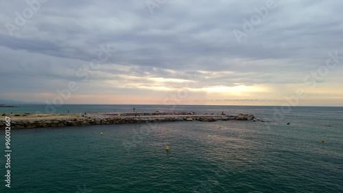 Arial shot flies over the Beach towards the Sunrise photo