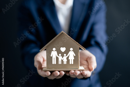 Wallpaper Mural Businesswomen holding house model with family icon, Real estate mortgage protection security safety business investment, home insurance residential home Torontodigital.ca