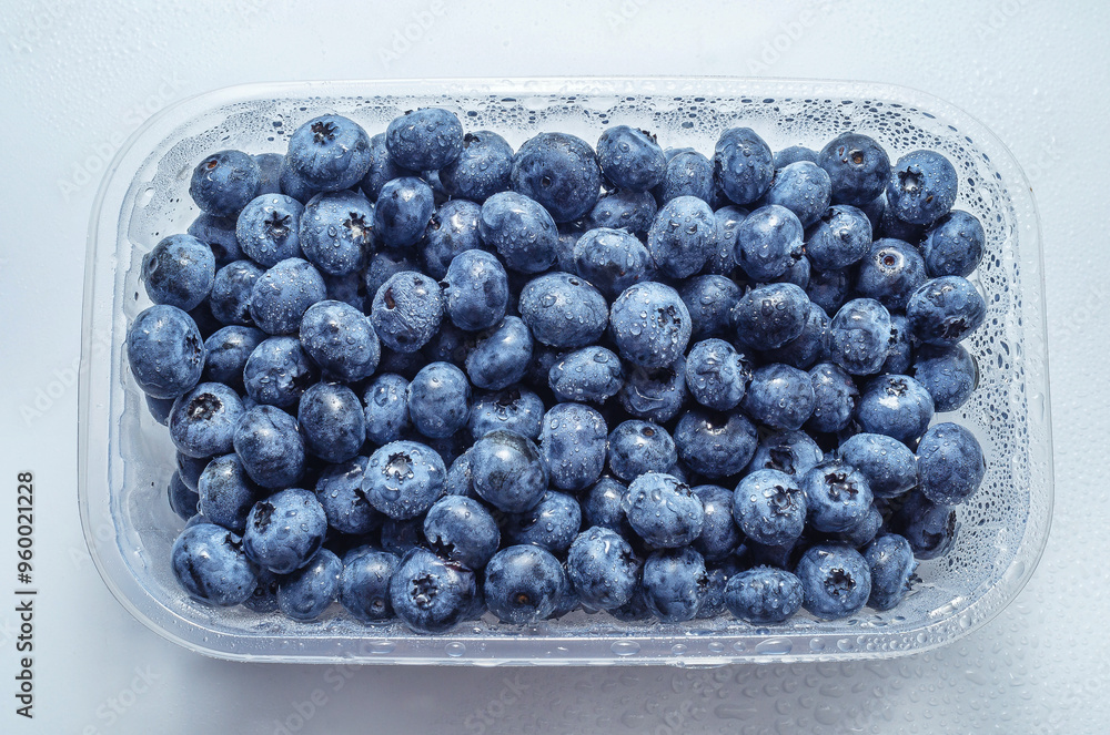 Box with fresh blueberries isolated on white. Top view. Concept of healthy eating. Weight loss. Box with fresh blueberries isolated on white. Top view. Concept of healthy eating. Weight loss.